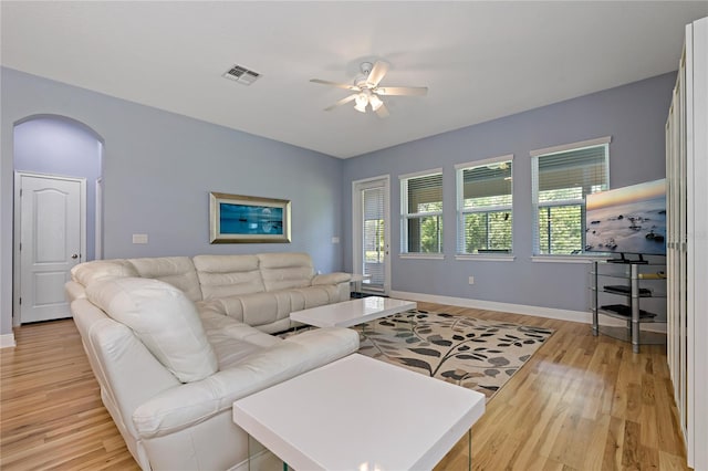 11401 Quiet Forest Dr, Tampa, FL 33635 - living area with light wood-style flooring, ceiling fan, arched walkways, and baseboards