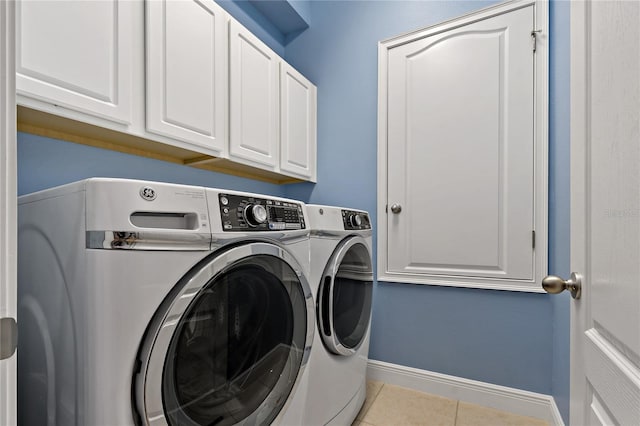 11401 Quiet Forest Dr, Tampa, FL 33635 - clothes washing area with washer and dryer, cabinet space, tile patterned flooring, and baseboards
