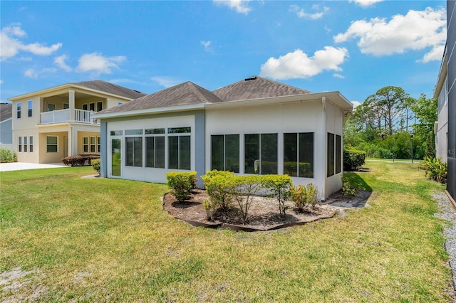 11401 Quiet Forest Dr, Tampa, FL 33635 - rear view of property featuring a lawn, stucco siding, and a sunroom