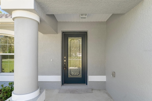 view of exterior entry with stucco siding