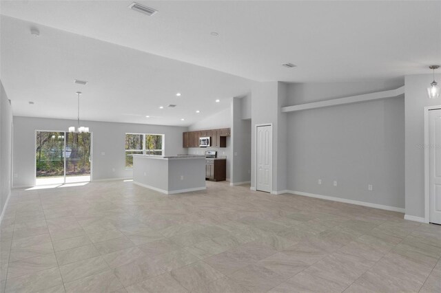 unfurnished living room with lofted ceiling, a chandelier, and baseboards