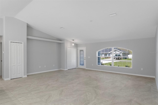 unfurnished living room featuring vaulted ceiling and baseboards