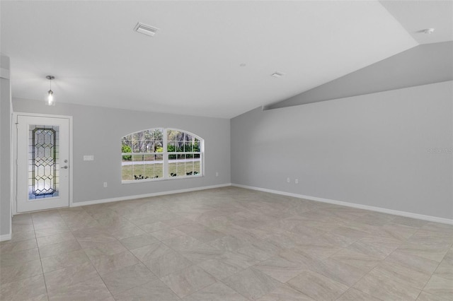 unfurnished living room featuring vaulted ceiling and baseboards