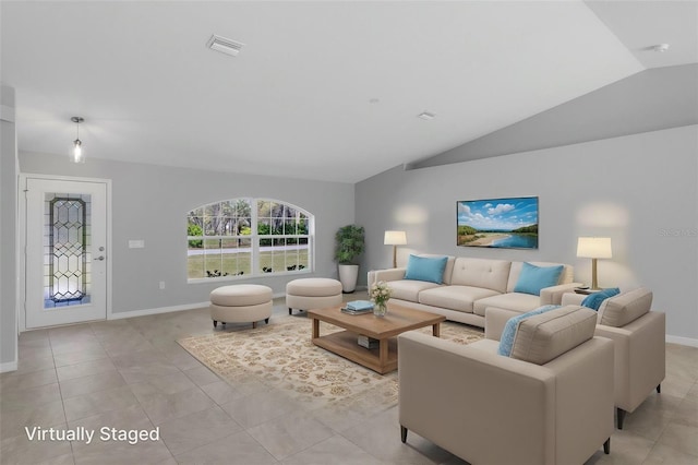 living area featuring vaulted ceiling, light tile patterned floors, and baseboards