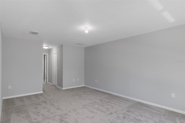 carpeted spare room with baseboards