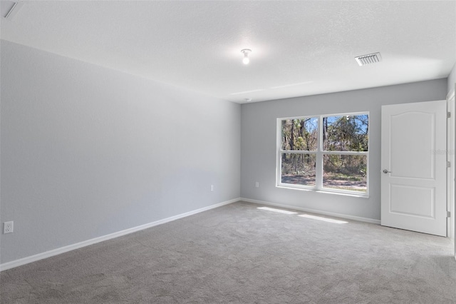 empty room featuring carpet flooring and baseboards