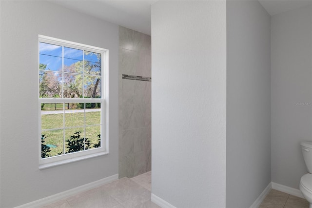 full bathroom with toilet, walk in shower, tile patterned floors, and baseboards