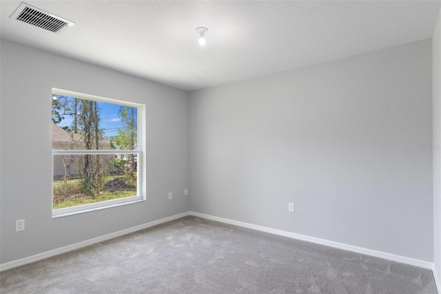 unfurnished room featuring carpet flooring and baseboards