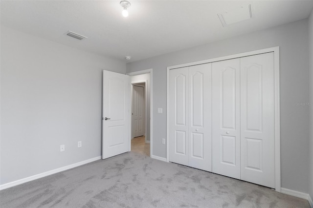 unfurnished bedroom featuring carpet, baseboards, and a closet