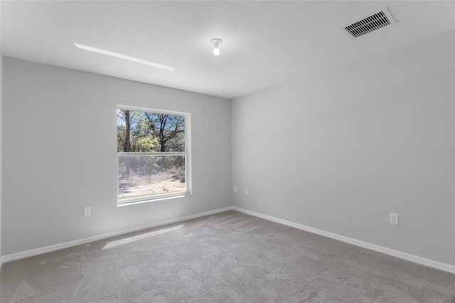 carpeted spare room with baseboards