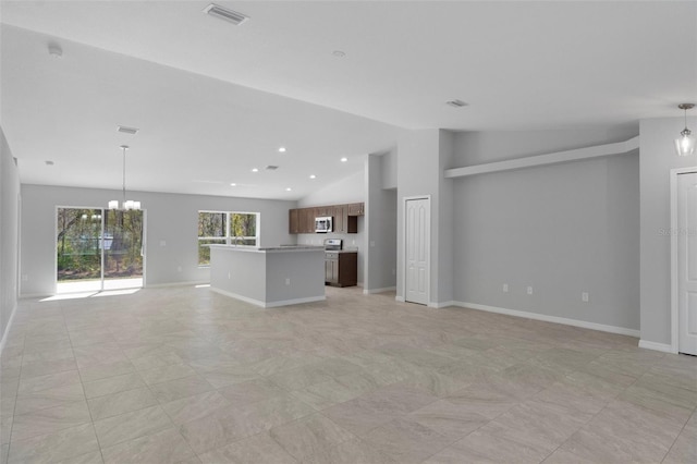 12192 Eskimo Curlew Rd, Weeki Wachee, FL 34614 - unfurnished living room with lofted ceiling, a chandelier, and baseboards