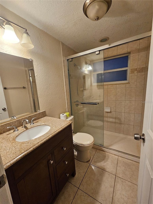6339 Delaware Ave, New Port Richey, FL 34653 - bathroom with a textured ceiling, vanity, a shower stall, a textured wall, and tile patterned flooring