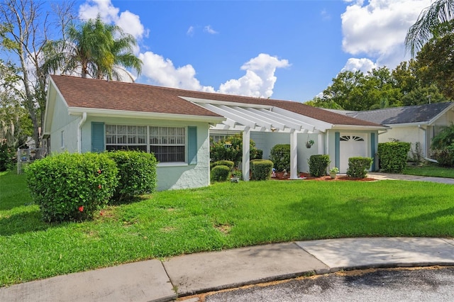 8021 Wildflower Row, Hudson, FL 34667 - single story home featuring an attached garage, a pergola, a front lawn, and stucco siding