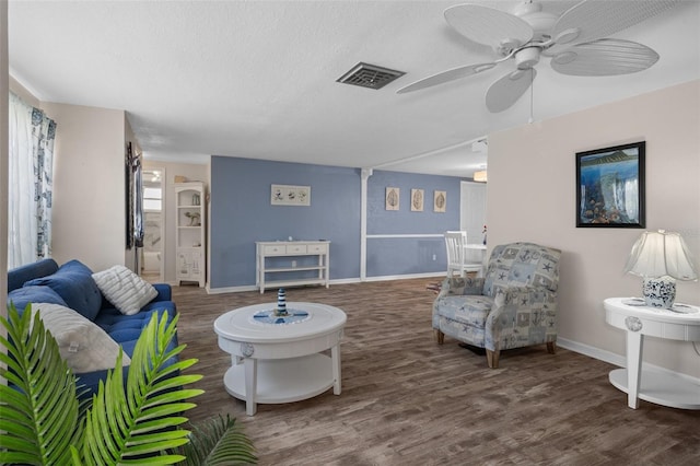 8021 Wildflower Row, Hudson, FL 34667 - living room with wood finished floors, a ceiling fan, a textured ceiling, and baseboards