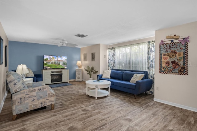 8021 Wildflower Row, Hudson, FL 34667 - living room with wood finished floors, a fireplace, and baseboards