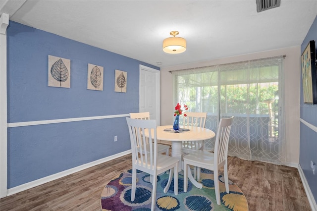 8021 Wildflower Row, Hudson, FL 34667 - dining space featuring wood finished floors and baseboards