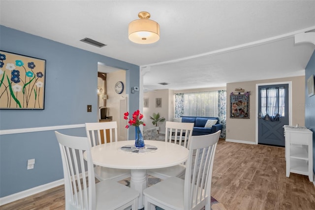 8021 Wildflower Row, Hudson, FL 34667 - dining room with baseboards and wood finished floors