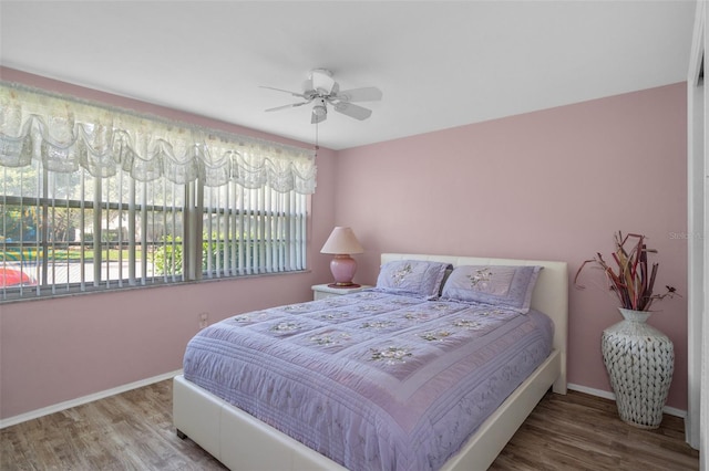8021 Wildflower Row, Hudson, FL 34667 - bedroom with wood finished floors, baseboards, and ceiling fan