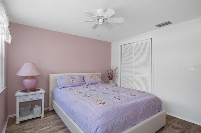 8021 Wildflower Row, Hudson, FL 34667 - bedroom with wood finished floors, a closet, a ceiling fan, and baseboards