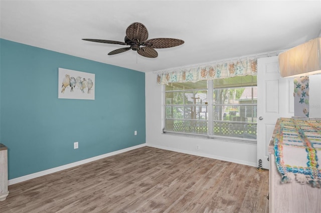 8021 Wildflower Row, Hudson, FL 34667 - unfurnished bedroom featuring baseboards, wood finished floors, and a ceiling fan