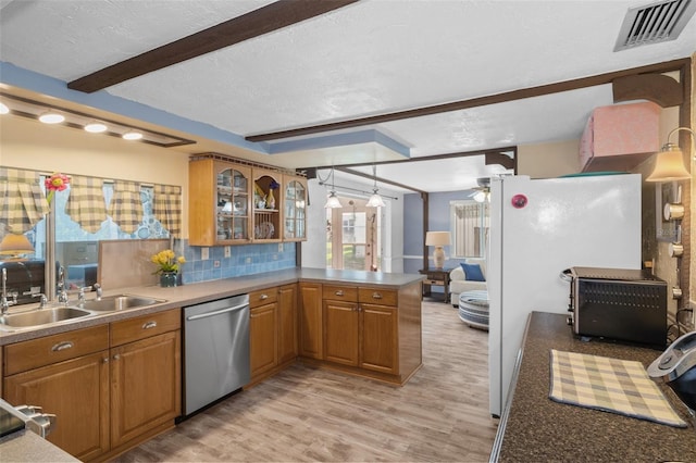 8021 Wildflower Row, Hudson, FL 34667 - kitchen featuring stainless steel dishwasher, a peninsula, a sink, light wood finished floors, and brown cabinetry