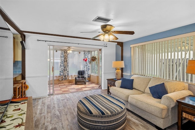 8021 Wildflower Row, Hudson, FL 34667 - living room with a ceiling fan and wood finished floors