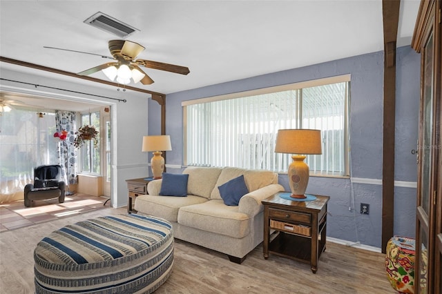 8021 Wildflower Row, Hudson, FL 34667 - living area featuring ceiling fan, wood finished floors, baseboards, and a textured wall
