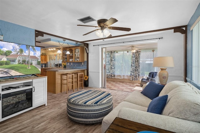 8021 Wildflower Row, Hudson, FL 34667 - living room with ceiling fan and wood finished floors