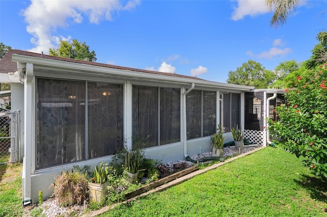 8021 Wildflower Row, Hudson, FL 34667 - view of home's exterior with a sunroom and a yard