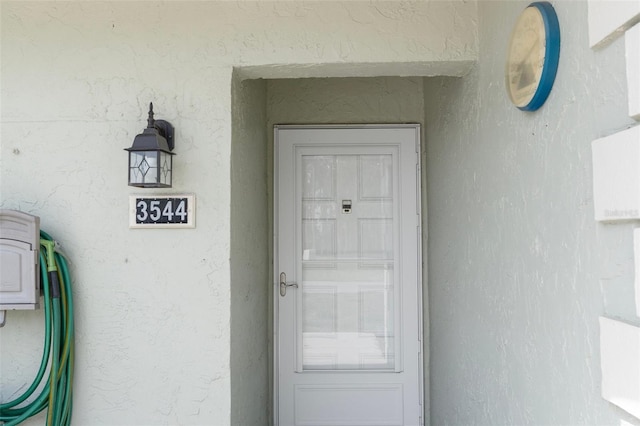 doorway to property with stucco siding