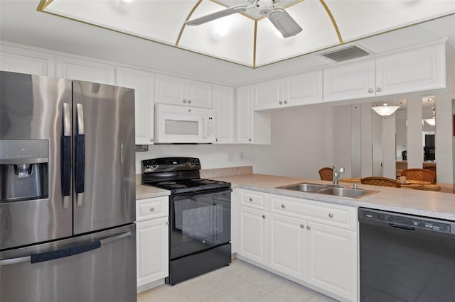 kitchen featuring black appliances, a sink, light countertops, and white cabinetry