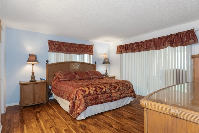 bedroom with wood finished floors and a textured ceiling