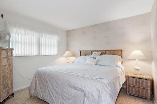 bedroom featuring carpet and baseboards