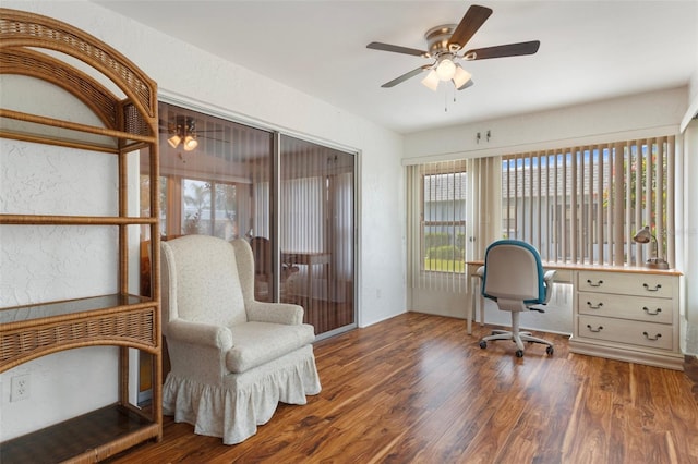 home office featuring plenty of natural light, wood finished floors, ceiling fan, and a textured wall