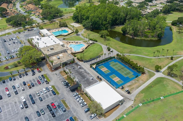 aerial view of a nearby body of water, a pool area, and a local golf course