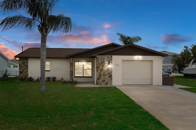 7520 Mako Dr, Hudson, FL 34667 - ranch-style home with stone siding, driveway, a garage, a lawn, and stucco siding