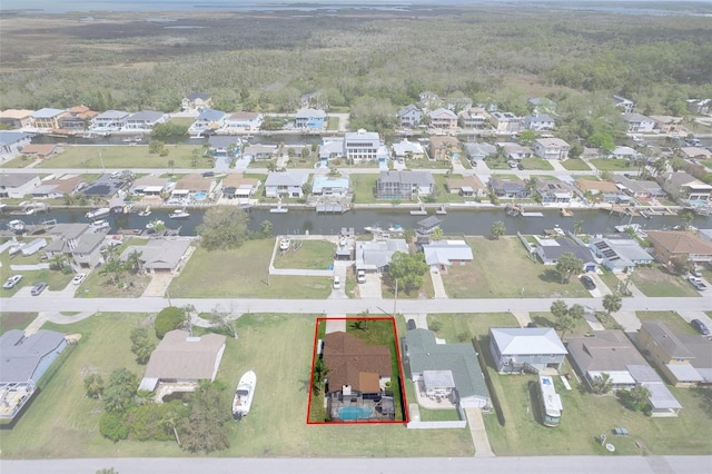 7520 Mako Dr, Hudson, FL 34667 - aerial perspective of suburban area featuring a heavily wooded area, property boundaries highlighted, and a large body of water