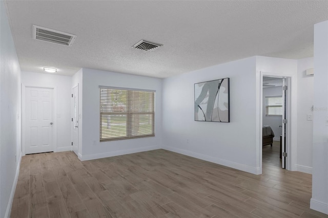 7520 Mako Dr, Hudson, FL 34667 - spare room featuring wood finished floors, a textured ceiling, and baseboards