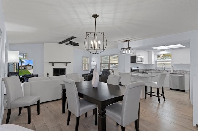 7520 Mako Dr, Hudson, FL 34667 - dining space featuring light wood-type flooring, a chandelier, and ceiling fan