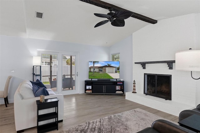 7520 Mako Dr, Hudson, FL 34667 - living area featuring ceiling fan, wood finished floors, a brick fireplace, and baseboards
