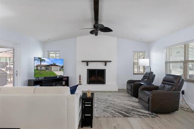 7520 Mako Dr, Hudson, FL 34667 - living room featuring wood finished floors, ceiling fan, a fireplace, and baseboards