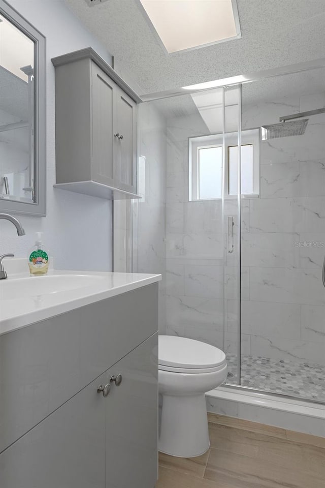 7520 Mako Dr, Hudson, FL 34667 - full bathroom with a marble finish shower, toilet, vanity, and wood finished floors