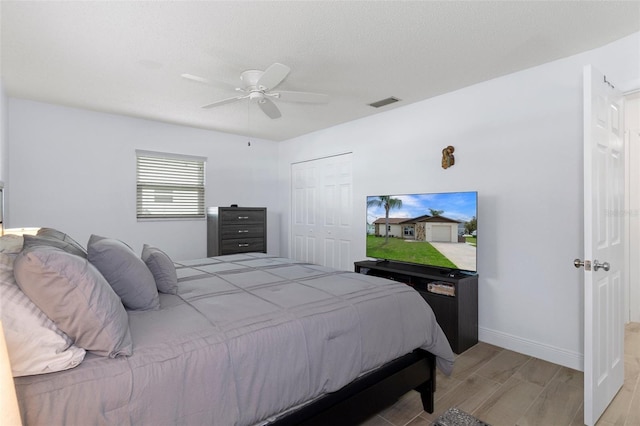 7520 Mako Dr, Hudson, FL 34667 - bedroom featuring wood tiled floors, a ceiling fan, a closet, and baseboards