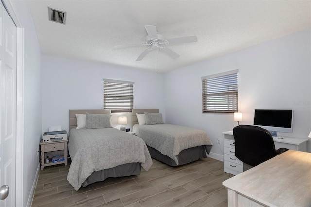 7520 Mako Dr, Hudson, FL 34667 - bedroom featuring multiple windows, light wood finished floors, an office area, and baseboards