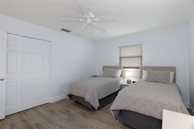 7520 Mako Dr, Hudson, FL 34667 - bedroom featuring a closet, wood finish floors, ceiling fan, and baseboards