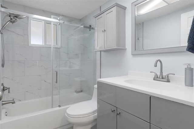 7520 Mako Dr, Hudson, FL 34667 - full bath with toilet, shower / bath combination with glass door, vanity, and a textured ceiling