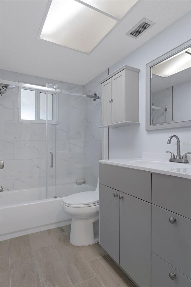 7520 Mako Dr, Hudson, FL 34667 - bathroom with toilet, vanity, and combined bath / shower with glass door