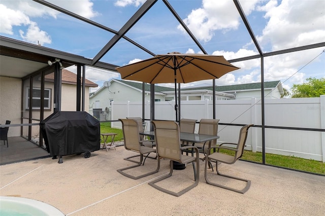 7520 Mako Dr, Hudson, FL 34667 - view of patio with a fenced backyard, outdoor dining area, glass enclosure, and a grill
