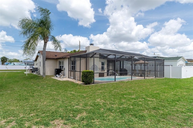 7520 Mako Dr, Hudson, FL 34667 - rear view of house with a patio area, stucco siding, a chimney, a lanai, and central air condition unit