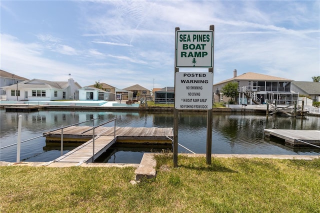 7520 Mako Dr, Hudson, FL 34667 - dock area featuring a residential view, a water view, and a lawn